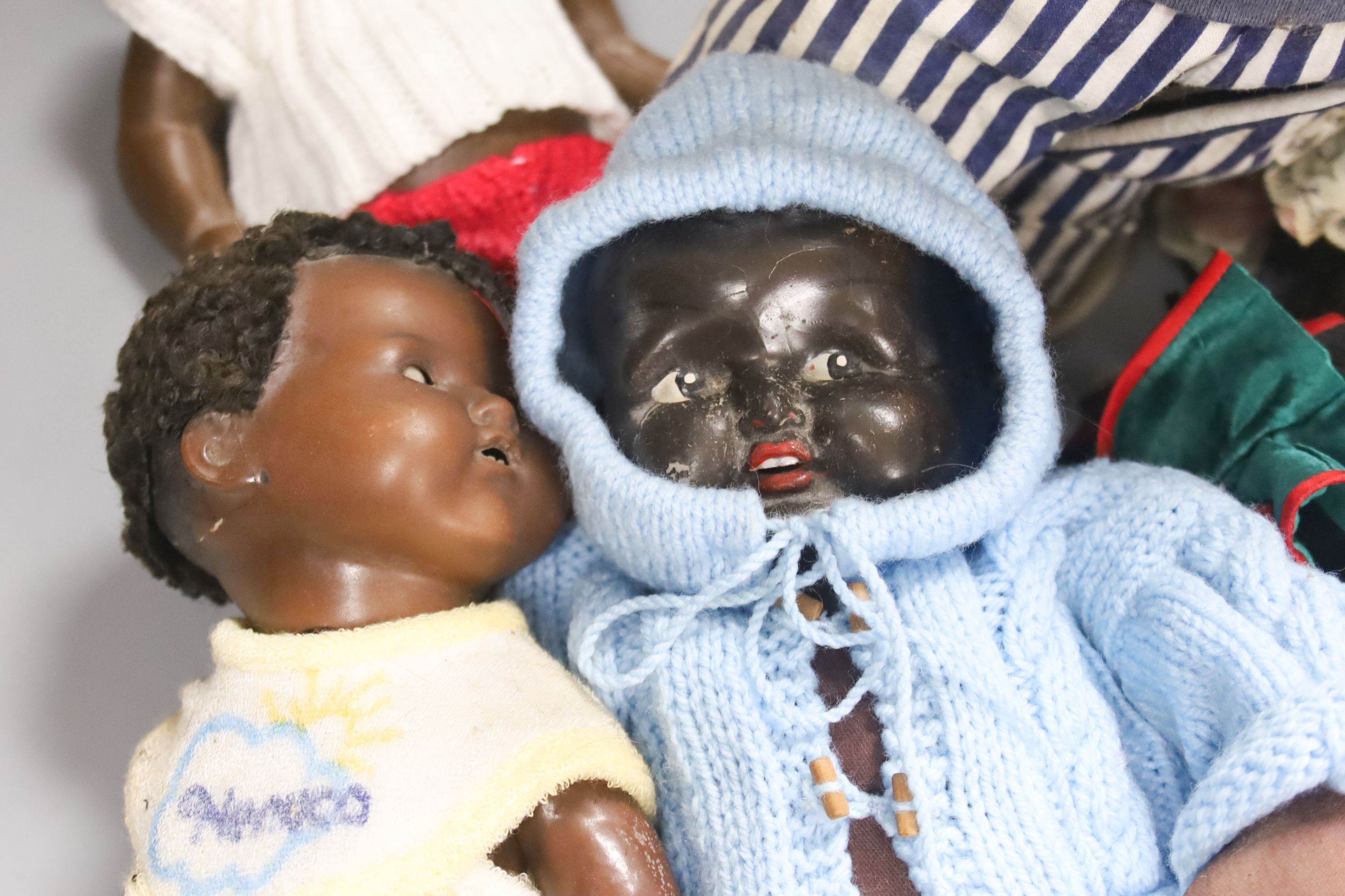 A black AM 351 cracked neck Schoneau & Hoffmeister jointed doll H13in. Black cream baby with wig crack to head H14in. two black dolls, one wood large sailor doll 20in.